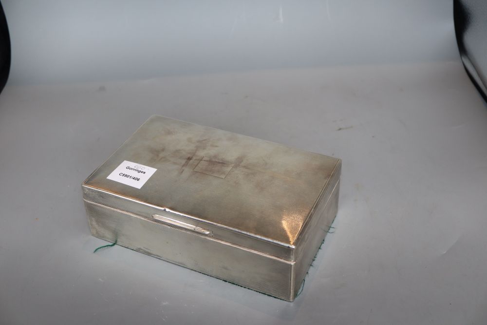 A 1930s engine turned silver rectangular cigarette box, William Comyns & Sons Ltd, London, 1936, 22.9cm, gross 35 oz.